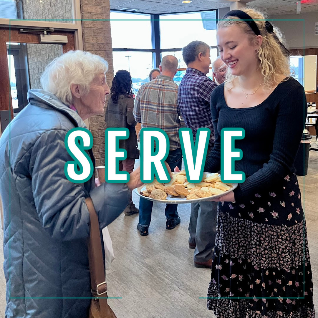 young woman serving dessert tray to an older woman teal and white lettering