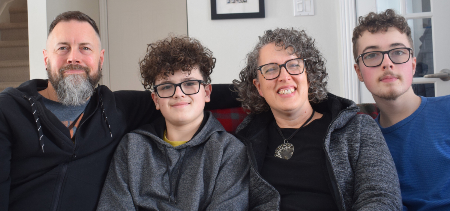 A family picture including a mom dad and 2 sons