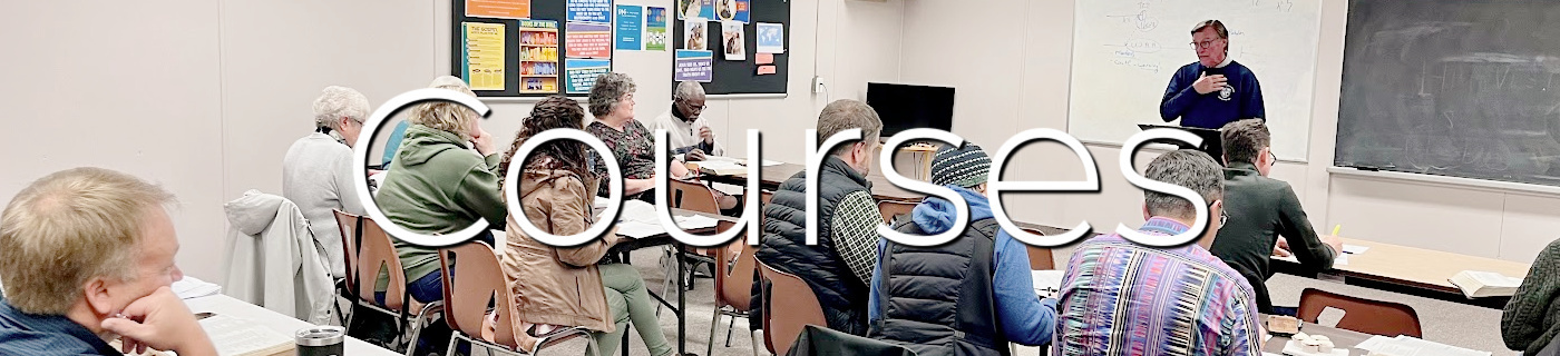 group of people learning in a classroom with white and black lettering